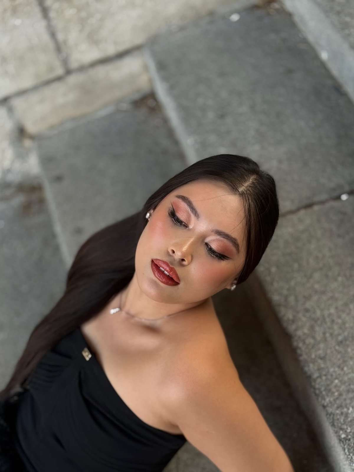 Editorial portrait with terracotta lip on stone steps